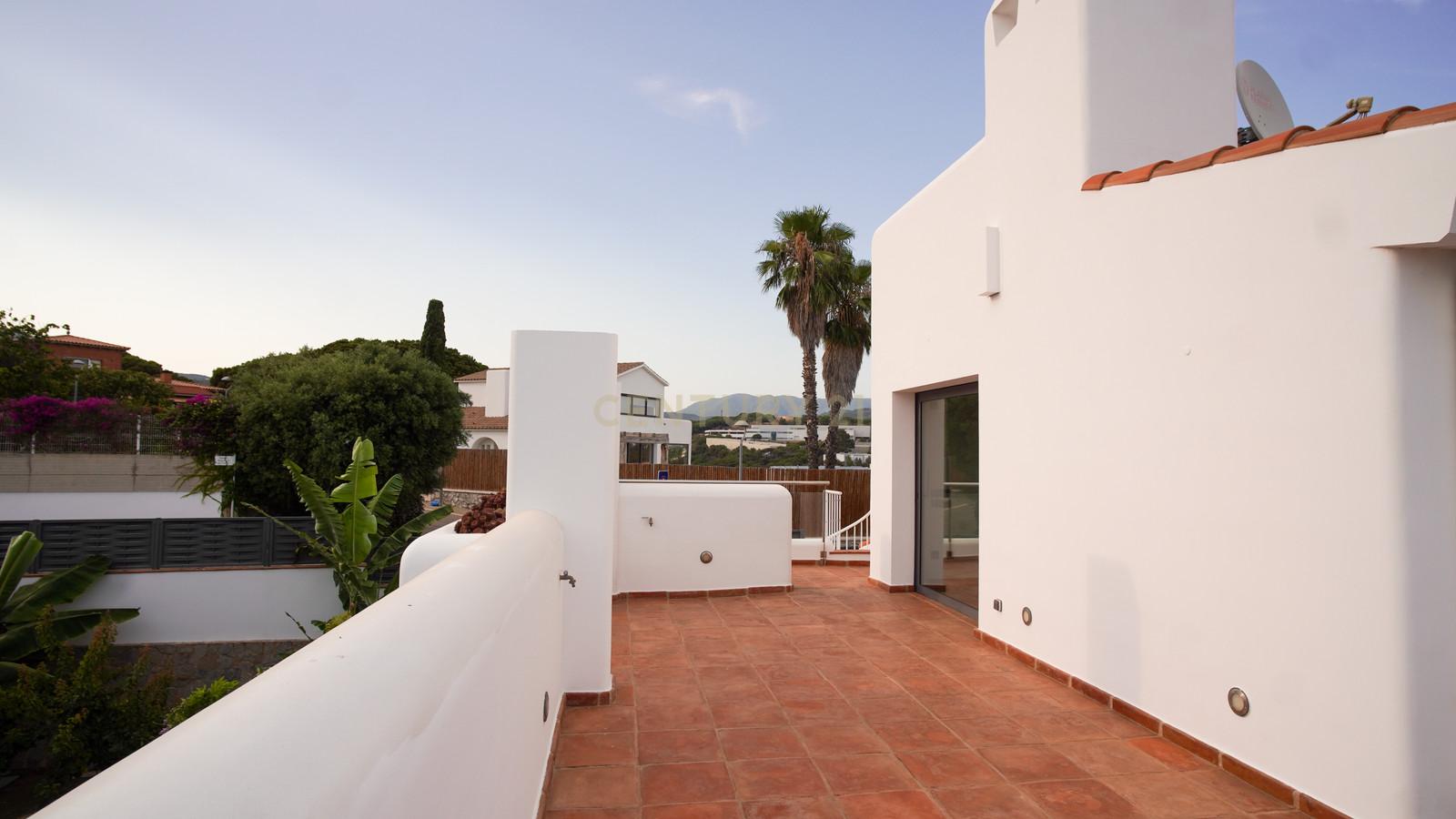 Private rooftop terrace of Villa Can Bonita with terracotta paving, lime-washed walls and potted Mediterranean plants.
