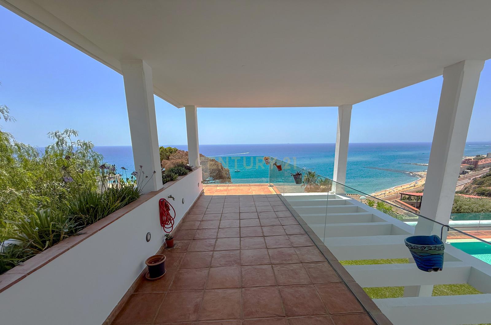 Villa Can Bonita's clipped lawn, 13-metre infinity pool and the Mediterranean seen from the upper terrace.