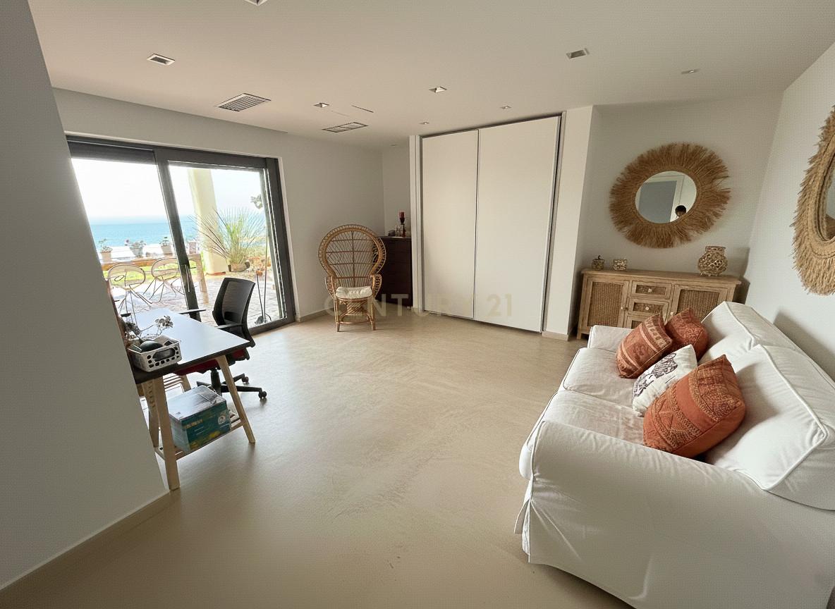 Private study at Villa Can Bonita with desk, ergonomic seating and full-height glazing onto the Mediterranean.